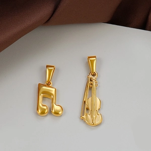 Polished 24K gold plated stainless steel musical note and violin pendant detail
