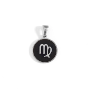 Macro view of a round Virgo zodiac charm with black background and silver stainless steel