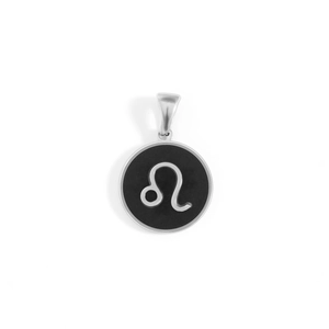 Macro shot of silver Leo zodiac pendant with black inlay and stainless steel border