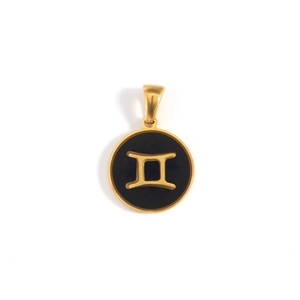 Macro detail of 18k gold plated black enamel Gemini constellation pendant accessory