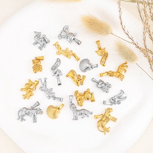 Detailed collection of 24k gold-plated animal charms like tiger, bear, and fox on a tray