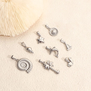 Polished stainless steel sea themed pendants featuring dolphin coconut tree and shell