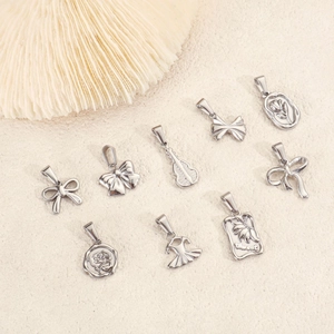 9-piece vintage bow and ballet dress pendants in 24k plated stainless steel