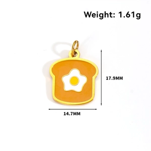 Detail view of a toast-shaped pendant with a white fried egg pattern and dimensions