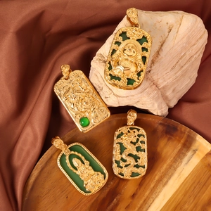 Detailed view of four golden rectangular pendants with green jade-like carvings