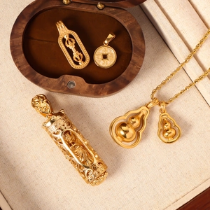 Macro detail of golden gourd pendants and religious charms on a premium wooden display box