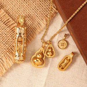Golden titanium steel calabash and cylinder prayer pendants on rustic wood and burlap