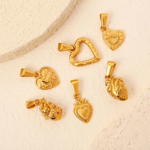 Ensemble détaillé de six pendentifs en forme de cœur dorés aux motifs gravés et creux