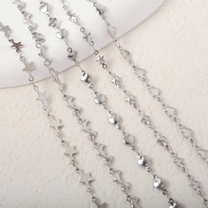 Detail of silver stainless steel necklaces with star, heart, and moon shaped charms