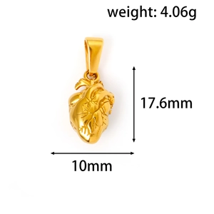Détail macro du pendentif cœur anatomique doré montrant les vaisseaux et les valves réels