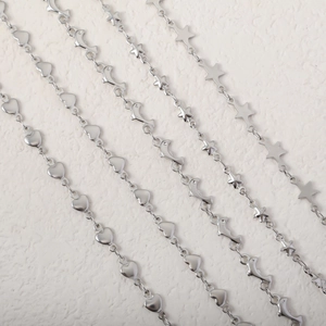 Minimalist stainless steel necklaces with heart, dolphin, and star charms on white surface