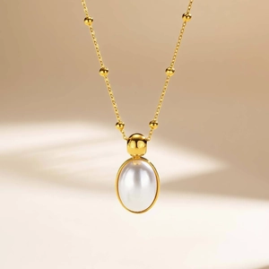Elegant gold satellite chain necklace with a large oval white pearl pendant for women