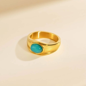 Macro view of vintage gold stainless steel ring with oval blue stone inlay detail