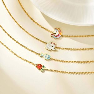 Detail view of colorful enamel unicorn, elephant, fish and tulip pendants on gold chains