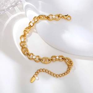 Detail of gold-plated anchor chain bracelet with white cubic zirconia and lobster clasp