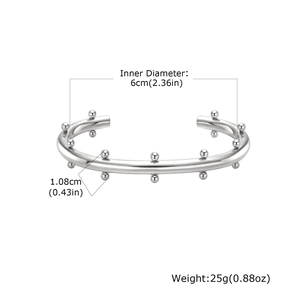 Brazalete abierto de acero inoxidable plateado con cuentas y detalles de talla 6cm