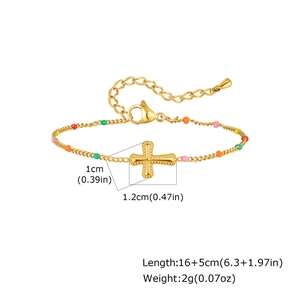 Detail of gold snake chain bracelet with colorful enamel beads and cross pendant
