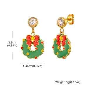 Detail of Christmas wreath earrings with red bow and white rhinestone on gold metal