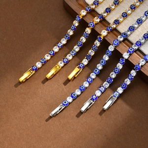 Golden and silver Evil Eye tennis bracelets with blue stones and cubic zirconia