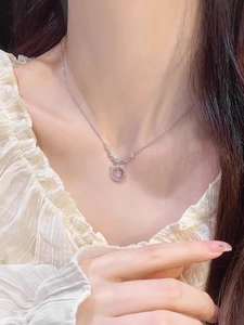 Macro view of S925 silver necklace with cat ear pendant and pink star gemstone
