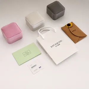 Luxury gift packaging set with velvet jewelry boxes, gift bag, and cleaning accessories