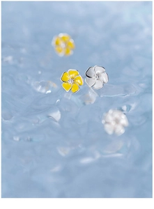 Macro shot of S925 silver five-petal flower stud earrings in white and yellow colors