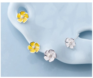 Close-up of S925 silver flower stud earrings in yellow and white enamel finish