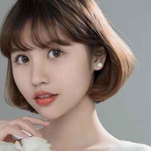 S925 sterling silver five-petal flower stud earrings on model with soft lighting