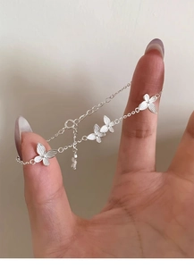Close-up of S925 silver butterfly bracelet with brushed texture on O-chain link