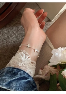Detailed view of silver butterfly bracelet with brushed texture on delicate chain