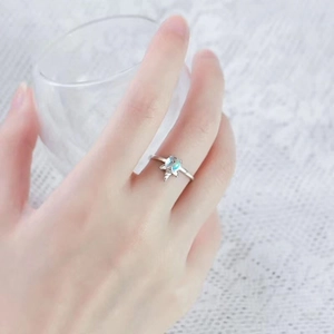 Unicorn moonstone open ring with silver finish shown on a model hand with white lace