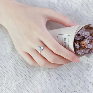 Detail of silver unicorn ring featuring a blue star-shaped moonstone on a lace background