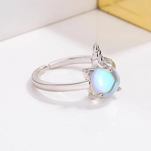 Close-up of adjustable unicorn ring with shimmering moonstone and silver carvings