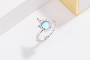 Detailed close-up of S925 hallmark on silver unicorn ring with moonstone center