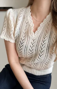 Detail of V-neck hollow out crochet knit top in creamy white soft mohair fabric