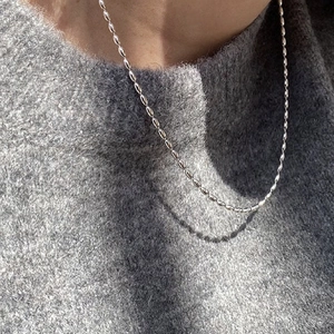 Minimalist S925 silver plated rice bead necklace layered on a grey knit sweater