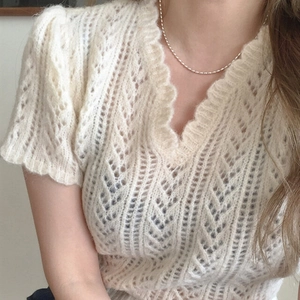 Elegant off-white short sleeve knit top featuring a V-neck and delicate scalloped edges