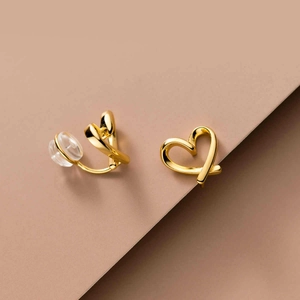 Elegant gold heart clip-on earrings with comfortable clear silicone pads for non-pierced ears