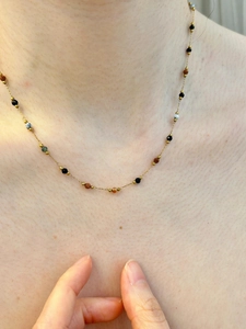 Dettaglio della collana di perle colorate dopamina con catena d'oro sul collo