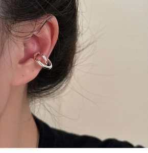 Close-up of minimalist silver double-ring ear cuff worn on model for a sleek look