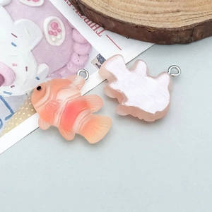 Detailed view of colorful resin tropical clownfish charms with silver metal jump rings
