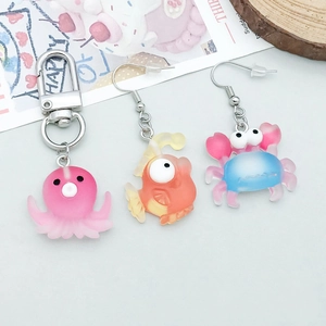 Detail of resin marine animal charms including pink octopus and orange goldfish