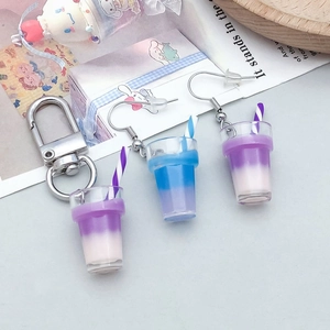 Close-up of resin bubble tea cup pendants with silver hooks and keychains in pastel colors