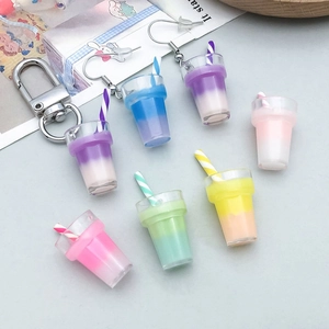 Macro shot of colorful gradient resin bubble tea pendants with straws for DIY jewelry making
