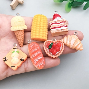 Mix of colorful resin food charms including mini cakes and bread for DIY jewelry making