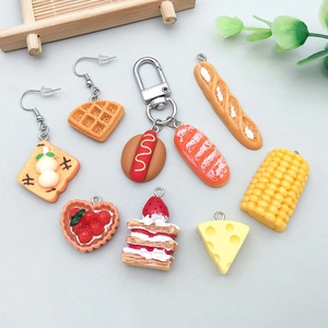 Detailed close-up of mixed resin food pendants including waffle and cake for DIY jewelry