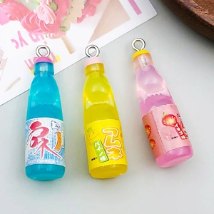 Macro view of miniature colorful resin soda bottle pendants with silver hanging loops