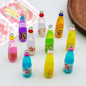 Macro shot of 10 colorful mini resin soda bottle charms with metal loops for DIY jewelry