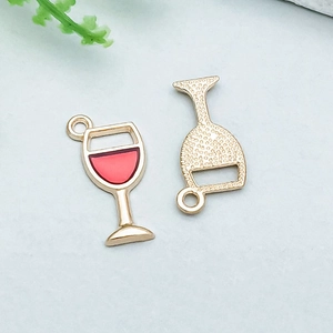 Macro detail of alloy red wine glass charms with gold plating and enamel for DIY jewelry