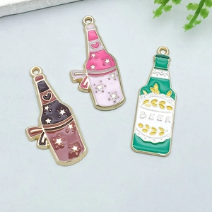 Detail of enamel wine bottle charms with gold borders and intricate patterns for DIY jewelry